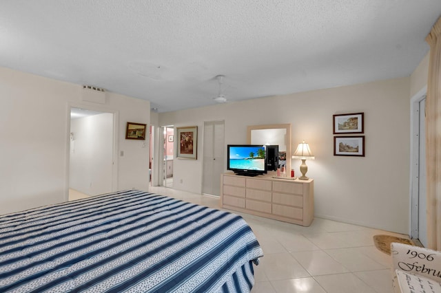1250 Club Dr W Unit C, Delray Beach, FL 33445 - bedroom with a textured ceiling and light tile patterned flooring