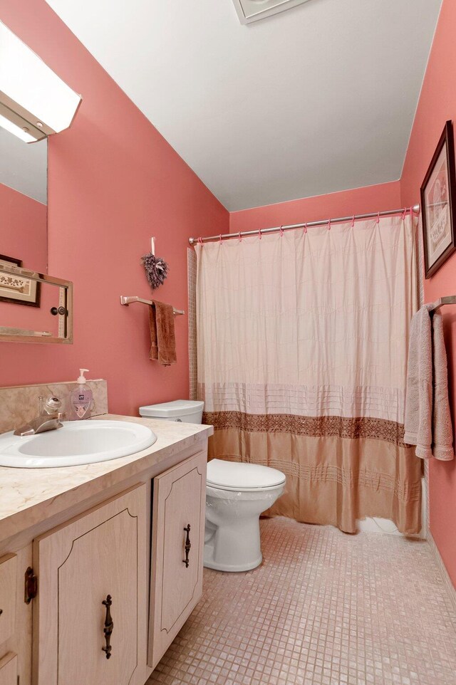 1250 Club Dr W Unit C, Delray Beach, FL 33445 - full bathroom featuring toilet, vanity, lofted ceiling, and tile patterned flooring