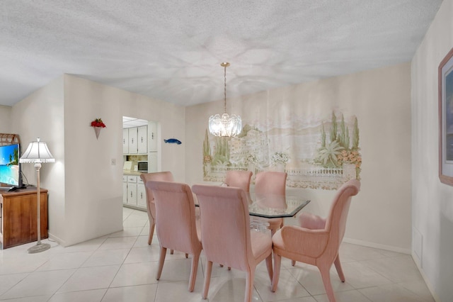 1250 Club Dr W Unit C, Delray Beach, FL 33445 - dining area featuring a chandelier, light tile patterned floors, baseboards, and a textured ceiling