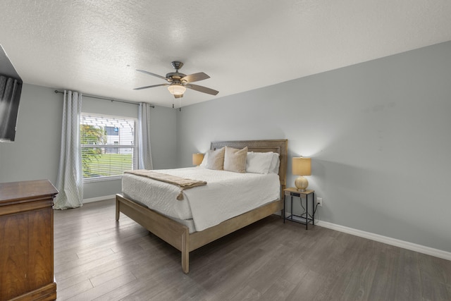 4312 SW Elaine Ct, Port Saint Lucie, FL 34953 - bedroom featuring wood finished floors, baseboards, a textured ceiling, and a ceiling fan