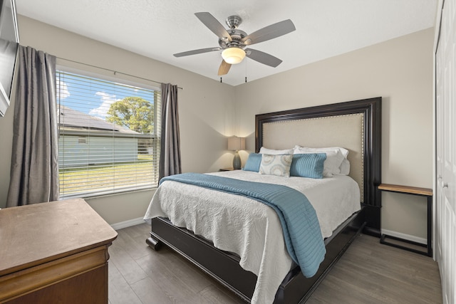 4312 SW Elaine Ct, Port Saint Lucie, FL 34953 - bedroom with baseboards, wood finished floors, and a ceiling fan