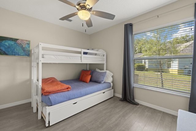 4312 SW Elaine Ct, Port Saint Lucie, FL 34953 - bedroom with wood finished floors, baseboards, and ceiling fan