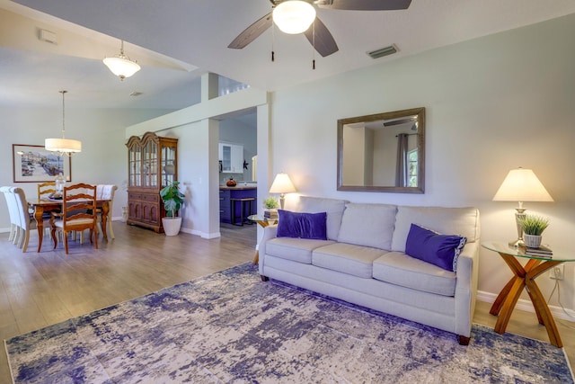 4312 SW Elaine Ct, Port Saint Lucie, FL 34953 - living area featuring wood finished floors, a ceiling fan, and baseboards