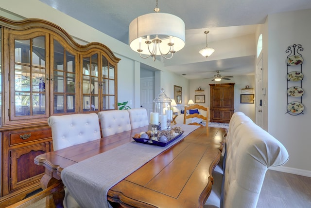 4312 SW Elaine Ct, Port Saint Lucie, FL 34953 - dining space featuring a ceiling fan, wood finished floors, baseboards, and a chandelier