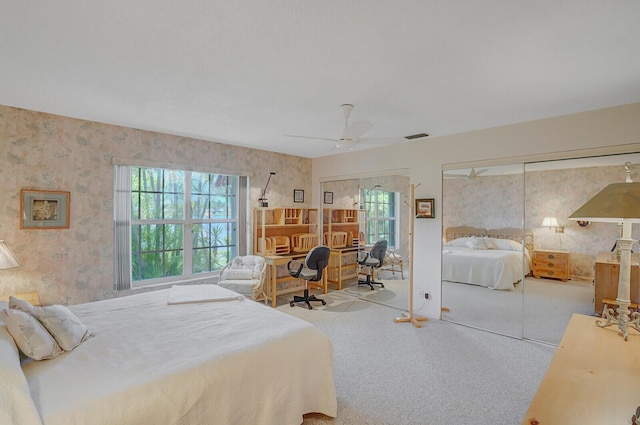 724 Nantucket Cir Unit A, Lake Worth, FL 33467 - carpeted bedroom with multiple windows, two closets, wallpapered walls, and ceiling fan