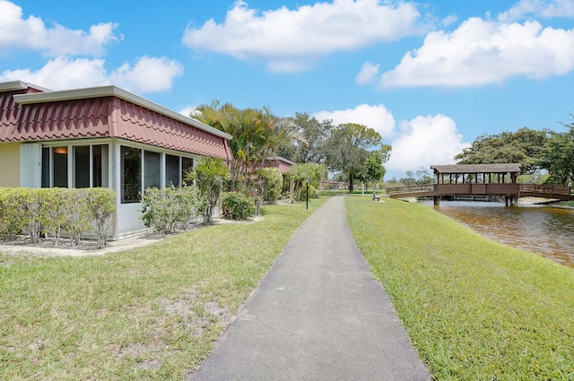 724 Nantucket Cir Unit A, Lake Worth, FL 33467 - view of property exterior with a yard and a water view