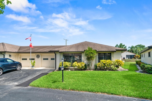 4858 Equestrian Rd Unit B, Boynton Beach, FL 33436 - view of front of property featuring a garage, driveway, a front lawn, and stucco siding