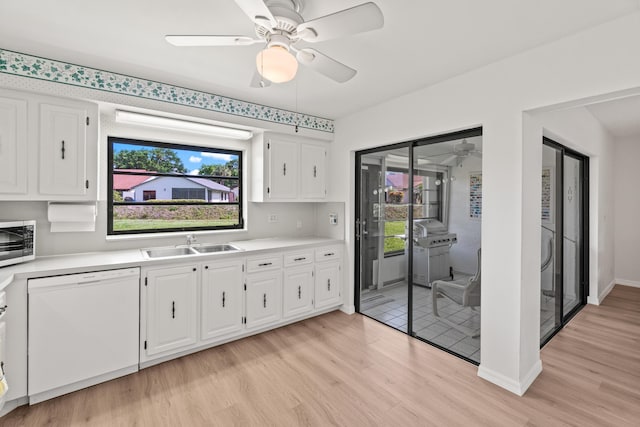 4858 Equestrian Rd Unit B, Boynton Beach, FL 33436 - kitchen with white dishwasher, a sink, a ceiling fan, stainless steel microwave, and light wood-type flooring