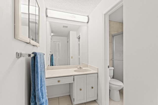4858 Equestrian Rd Unit B, Boynton Beach, FL 33436 - bathroom with a textured ceiling, tile patterned flooring, toilet, vanity, and a shower with shower door