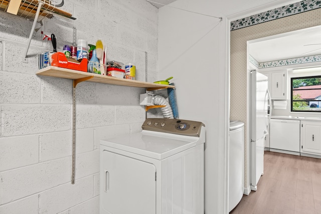 4858 Equestrian Rd Unit B, Boynton Beach, FL 33436 - laundry room with light wood-type flooring, washing machine and clothes dryer, wallpapered walls, and concrete block wall