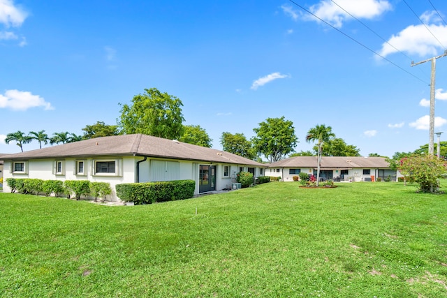 4858 Equestrian Rd Unit B, Boynton Beach, FL 33436 - back of property with a lawn and stucco siding
