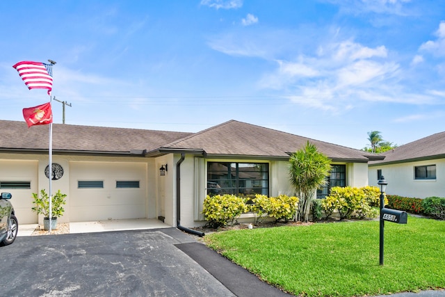 4858 Equestrian Rd Unit B, Boynton Beach, FL 33436 - ranch-style home featuring asphalt driveway, a garage, a front lawn, a shingled roof, and stucco siding