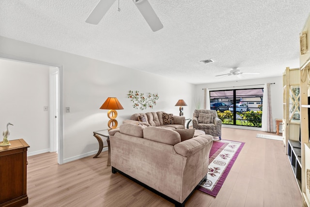 4858 Equestrian Rd Unit B, Boynton Beach, FL 33436 - living room featuring ceiling fan, light wood finished floors, and a textured ceiling
