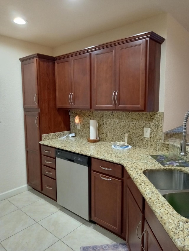 2 Antigua Ln, Port Saint Lucie, FL 34952 - kitchen with stainless steel dishwasher, a sink, light tile patterned floors, tasteful backsplash, and light stone counters