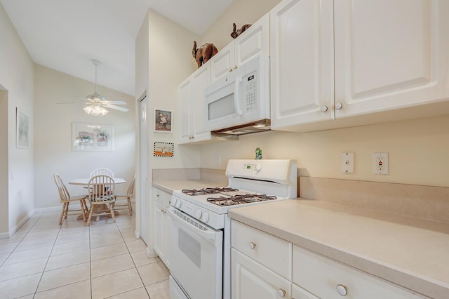 257 NW Toscane Trl, Port Saint Lucie, FL 34986 - kitchen with white appliances, lofted ceiling, white cabinets, light tile patterned floors, and light countertops