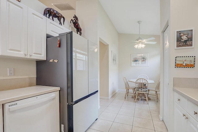 257 NW Toscane Trl, Port Saint Lucie, FL 34986 - kitchen featuring white dishwasher, a ceiling fan, freestanding refrigerator, white cabinets, and light tile patterned floors