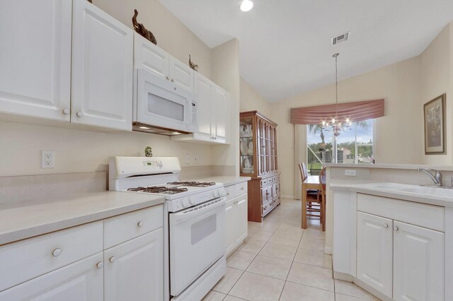 257 NW Toscane Trl, Port Saint Lucie, FL 34986 - kitchen featuring white appliances, a chandelier, a sink, vaulted ceiling, and white cabinets