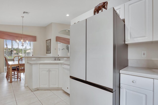 257 NW Toscane Trl, Port Saint Lucie, FL 34986 - kitchen with white appliances, a sink, white cabinets, light tile patterned floors, and recessed lighting
