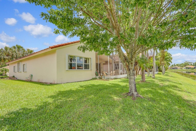 257 NW Toscane Trl, Port Saint Lucie, FL 34986 - rear view of house with a tile roof, stucco siding, and a yard