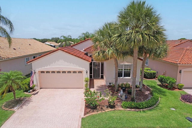 257 NW Toscane Trl, Port Saint Lucie, FL 34986 - mediterranean / spanish-style home with an attached garage, decorative driveway, stucco siding, a front lawn, and a tiled roof