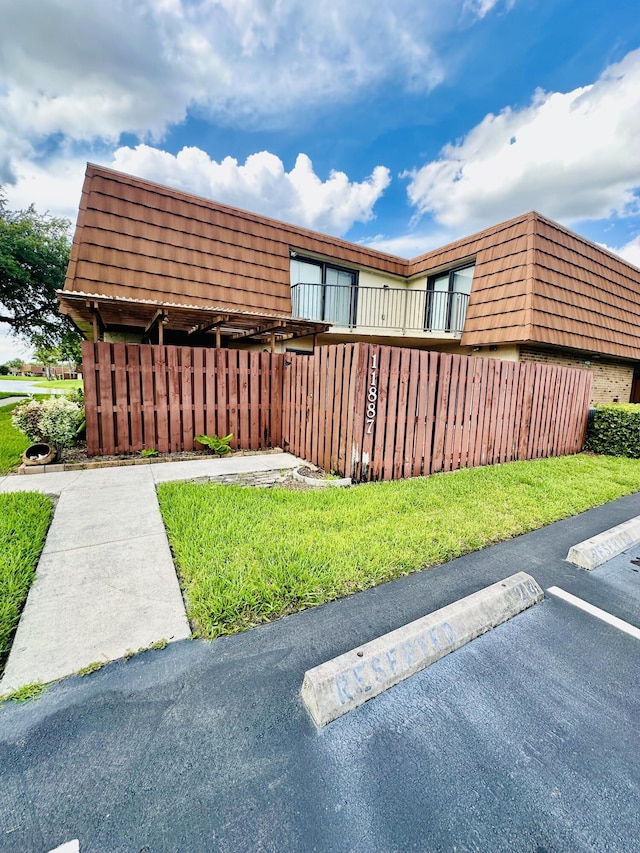 11887 SW 13th Ct, Davie, FL 33325 - view of side of property with mansard roof and uncovered parking