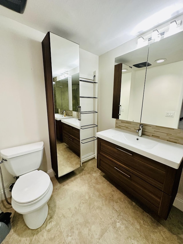 11887 SW 13th Ct, Davie, FL 33325 - bathroom featuring two vanities, toilet, and decorative backsplash