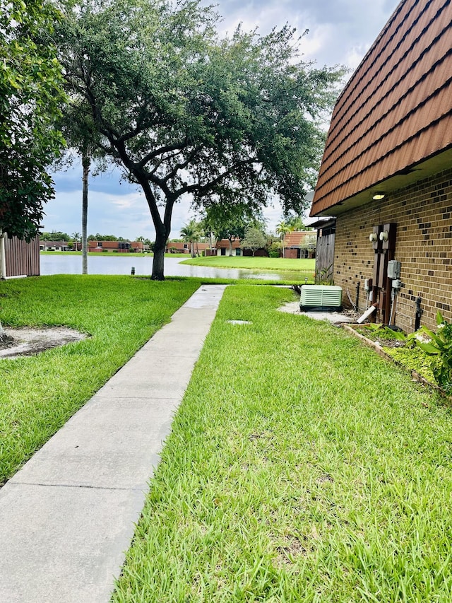 11887 SW 13th Ct, Davie, FL 33325 - view of grassy yard featuring a water view and cooling unit
