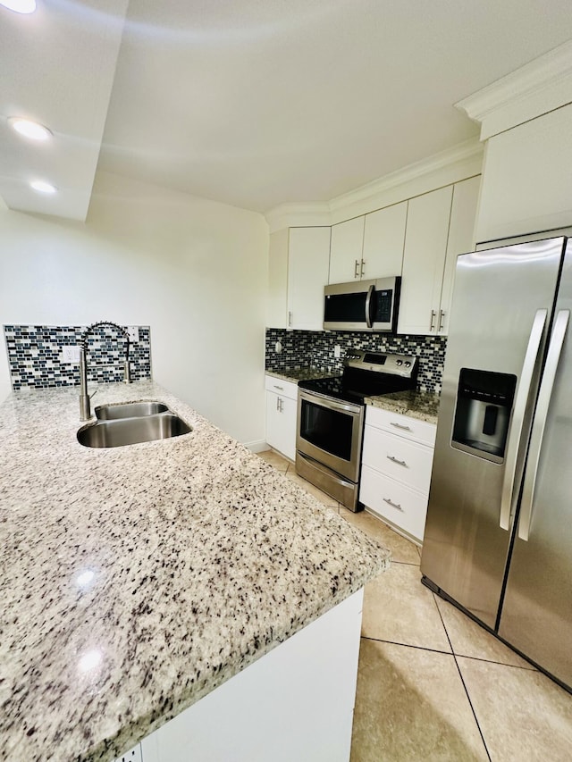 11887 SW 13th Ct, Davie, FL 33325 - kitchen with stainless steel appliances, a sink, tasteful backsplash, and light stone countertops
