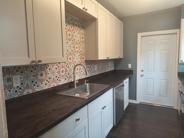 626 Texas Ct, Fort Pierce, FL 34950 - kitchen with a sink, dishwasher, tasteful backsplash, dark wood-style floors, and white cabinetry