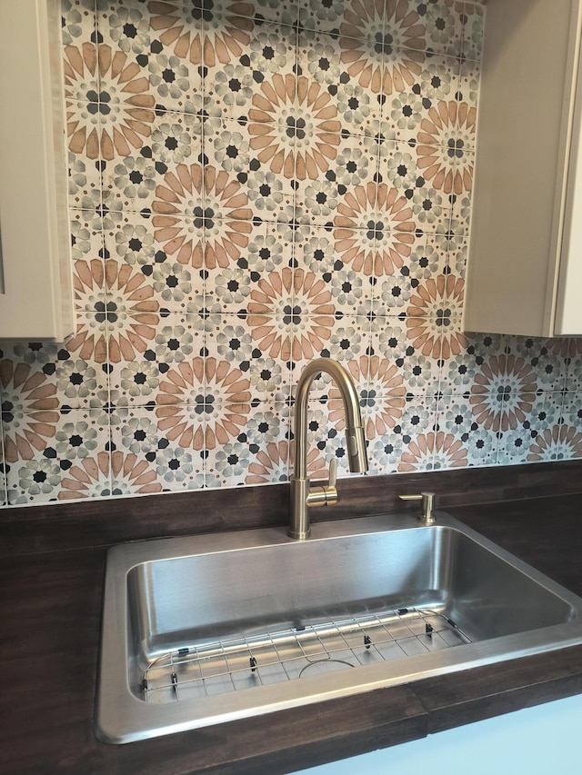 626 Texas Ct, Fort Pierce, FL 34950 - kitchen view of a sink, tasteful backsplash, and cream cabinetry