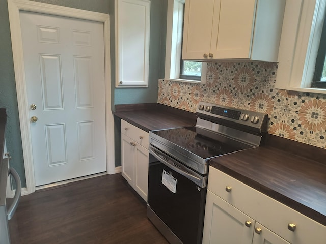 626 Texas Ct, Fort Pierce, FL 34950 - kitchen with stainless steel electric stove, butcher block counters, backsplash, dark wood-type flooring, and white cabinets