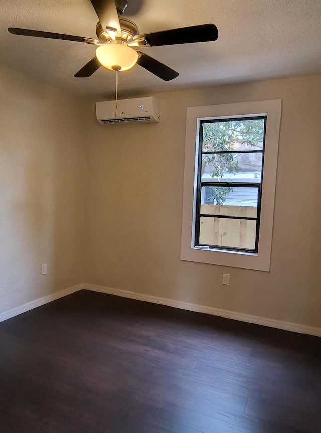 626 Texas Ct, Fort Pierce, FL 34950 - spare room with a wall mounted air conditioner, dark wood-style floors, a textured ceiling, baseboards, and ceiling fan