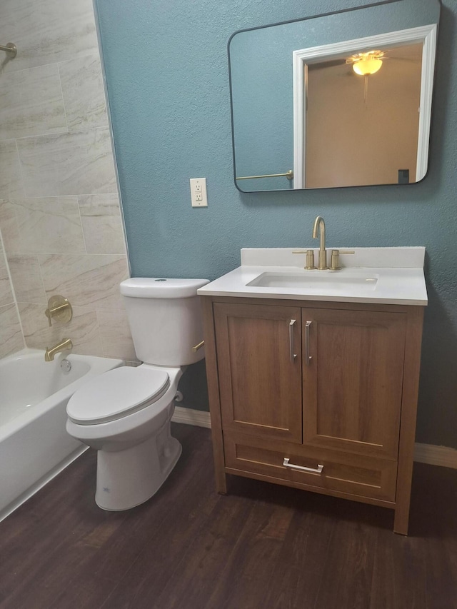 626 Texas Ct, Fort Pierce, FL 34950 - full bathroom with baseboards, vanity, wood finished floors, toilet, and washtub / shower combination