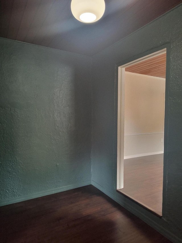 626 Texas Ct, Fort Pierce, FL 34950 - empty room featuring wood finished floors, a textured wall, and baseboards