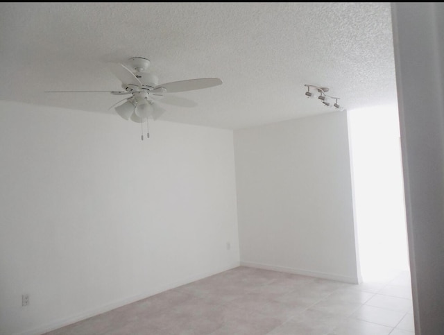 614 SW Jeanne St, Port Saint Lucie, FL 34953 - spare room featuring ceiling fan, track lighting, and a textured ceiling