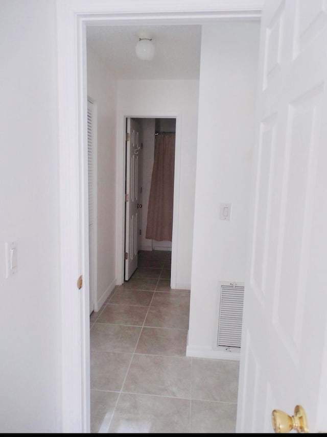 614 SW Jeanne St, Port Saint Lucie, FL 34953 - hall featuring light tile patterned floors and baseboards