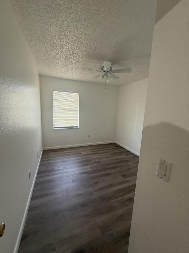 614 SW Jeanne St, Port Saint Lucie, FL 34953 - unfurnished room with a ceiling fan, a textured ceiling, dark wood-style flooring, and baseboards