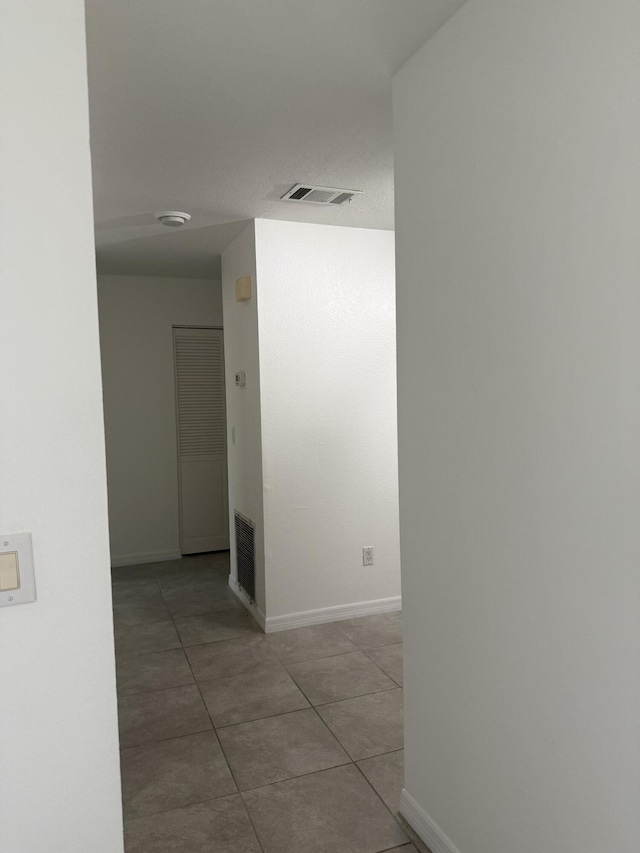 614 SW Jeanne St, Port Saint Lucie, FL 34953 - hallway with baseboards and tile patterned flooring