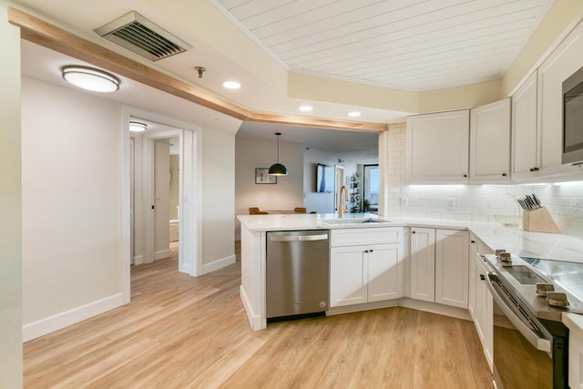 9650 S Ocean Dr Unit 1604, Jensen Beach, FL 34957 - kitchen with stainless steel appliances, a sink, recessed lighting, light wood-style flooring, and white cabinetry