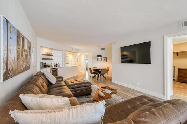 9650 S Ocean Dr Unit 1604, Jensen Beach, FL 34957 - living area featuring light wood-style flooring, baseboards, and wine cooler
