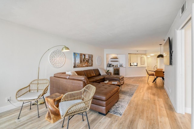 9650 S Ocean Dr Unit 1604, Jensen Beach, FL 34957 - living room with light wood finished floors, baseboards, and beverage cooler
