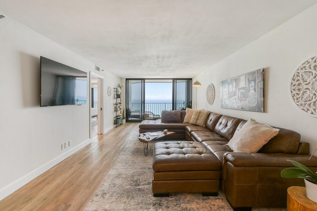 9650 S Ocean Dr Unit 1604, Jensen Beach, FL 34957 - living room with wood finished floors, expansive windows, and baseboards