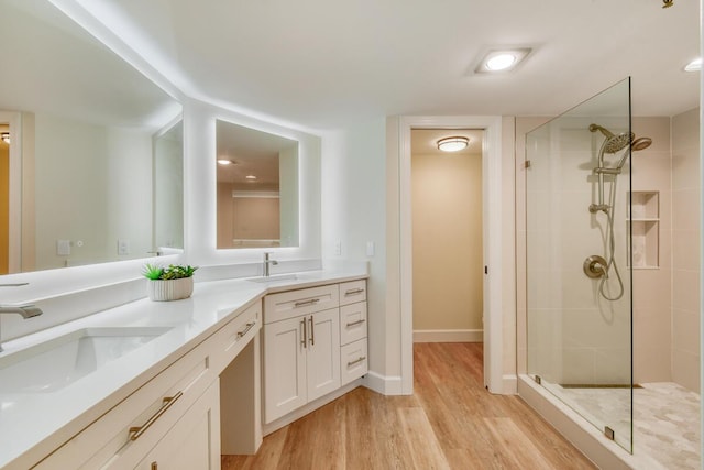 9650 S Ocean Dr Unit 1604, Jensen Beach, FL 34957 - full bath featuring a tile shower, double vanity, wood finished floors, and baseboards