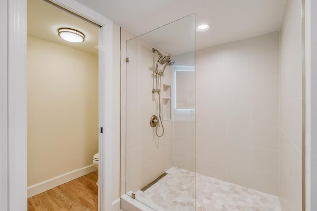 9650 S Ocean Dr Unit 1604, Jensen Beach, FL 34957 - bathroom featuring tiled shower, toilet, wood finished floors, and baseboards