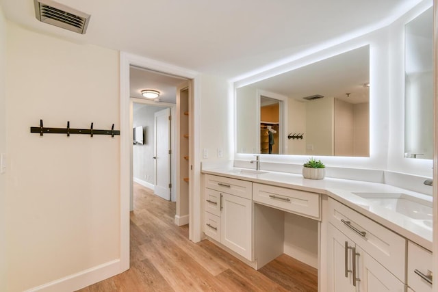 9650 S Ocean Dr Unit 1604, Jensen Beach, FL 34957 - bathroom featuring double vanity, wood finished floors, and baseboards