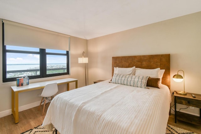 9650 S Ocean Dr Unit 1604, Jensen Beach, FL 34957 - bedroom featuring wood finished floors, baseboards, and a desk