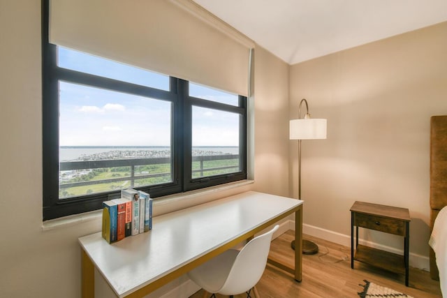 9650 S Ocean Dr Unit 1604, Jensen Beach, FL 34957 - home office with wood finished floors, baseboards, and a water view