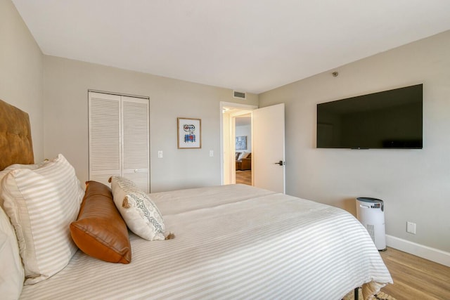 9650 S Ocean Dr Unit 1604, Jensen Beach, FL 34957 - bedroom with wood finished floors, a closet, and baseboards
