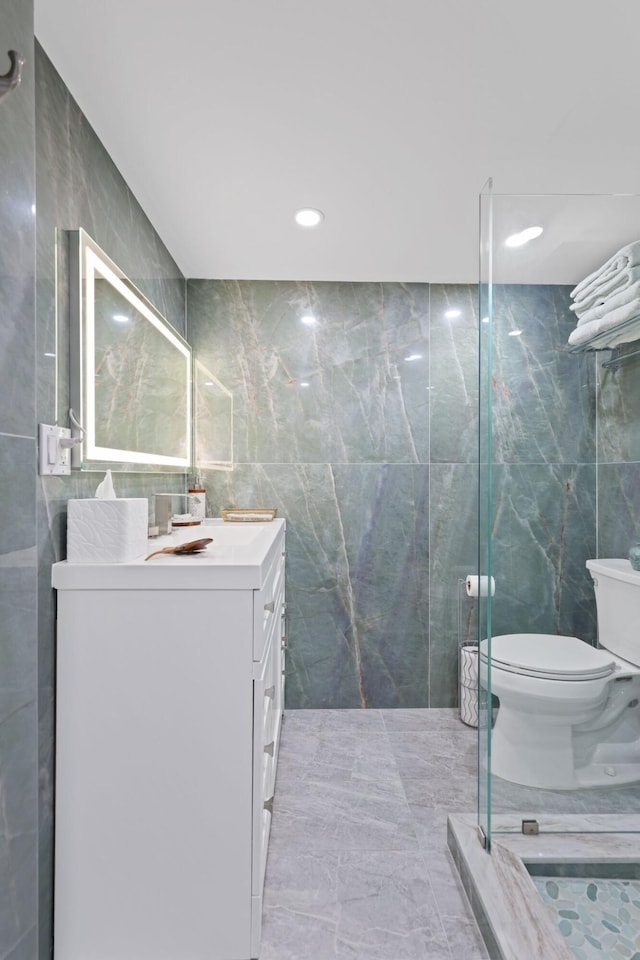 12 Royal Palm Way Unit 605, Boca Raton, FL 33432 - bathroom featuring tile walls, toilet, vanity, marble finish flooring, and recessed lighting