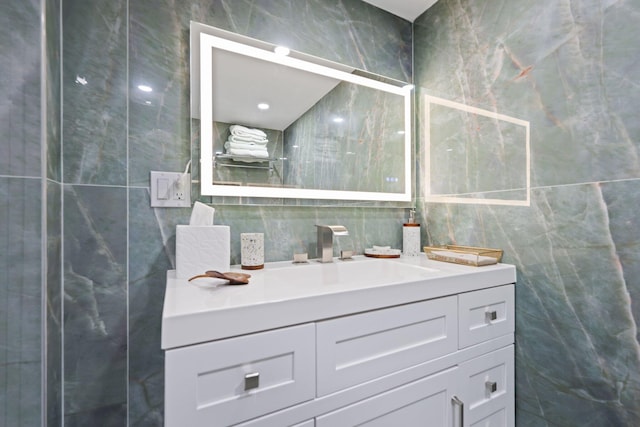 12 Royal Palm Way Unit 605, Boca Raton, FL 33432 - bathroom featuring tile walls, vanity, and tasteful backsplash